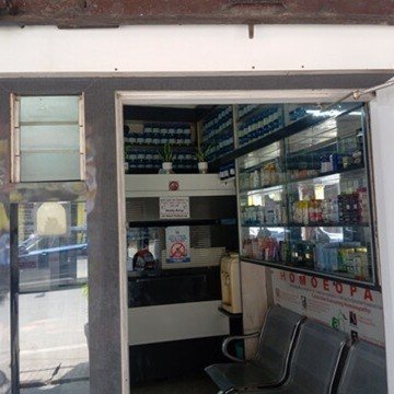 Entrance of Anand Homeo Care clinic with medicine shelves visible, Lalbagh