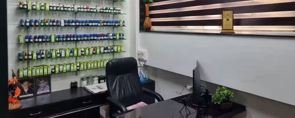 Consultation desk with homeopathic medicine wall at Anand Homeo Care, Lalbagh, Lucknow