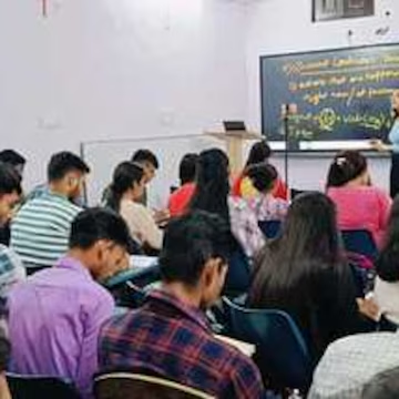 Coaching class in progress with students taking notes