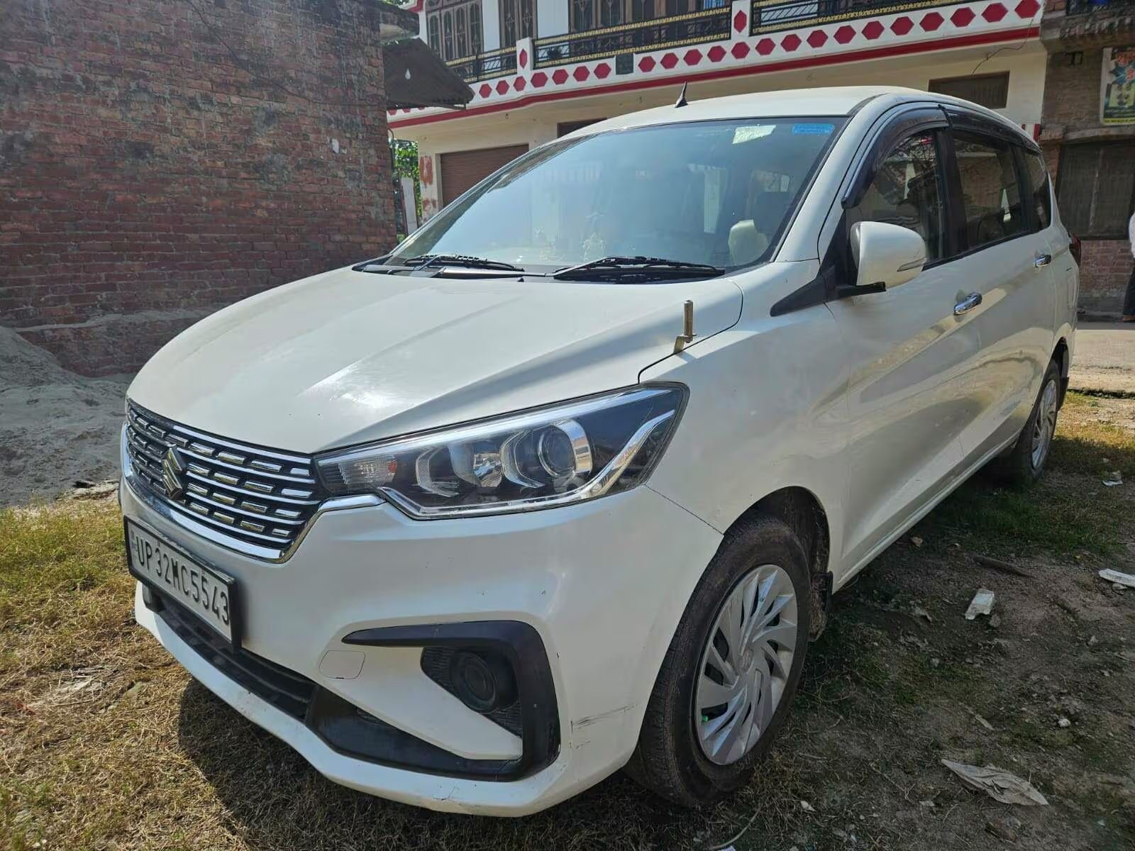 White Maruti Ertiga tour car from the Awadh Travels fleet, car rental and travel agent in Rajaji Puram Lucknow