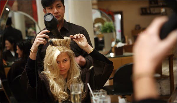 Stylist blow-drying client hair at Bhargavas salon