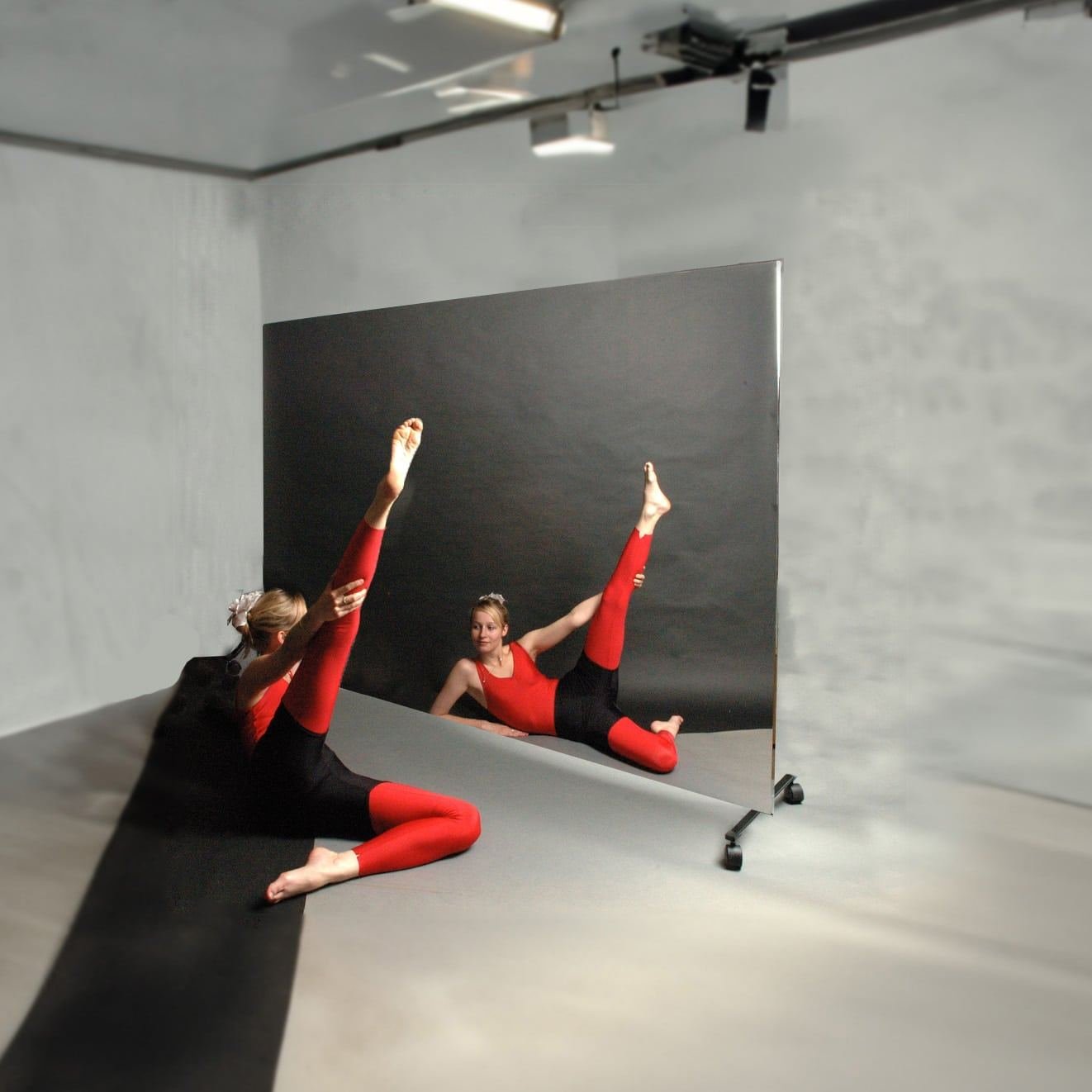 Dancer stretching by the mirror