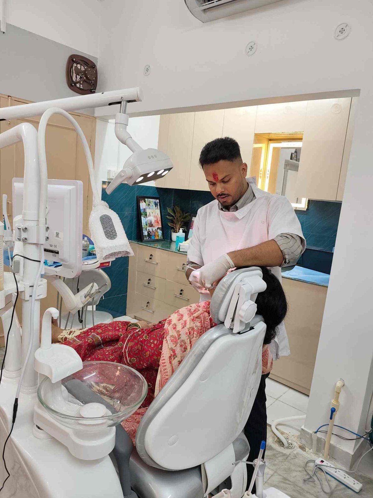 Dr. Kartikey treating a patient on the dental chair at Dental Arc, Aliganj