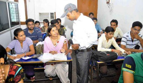 Tuition classroom with teacher explaining a topic at Excellent Tutorial Classes Balaganj