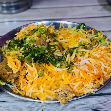 Mutton biryani topped with coriander at Idrees, Chowk