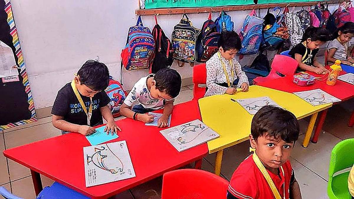 Kids doing drawing and craft activity in class