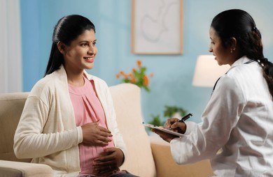 Nurse counseling an expectant mother about delivery planning