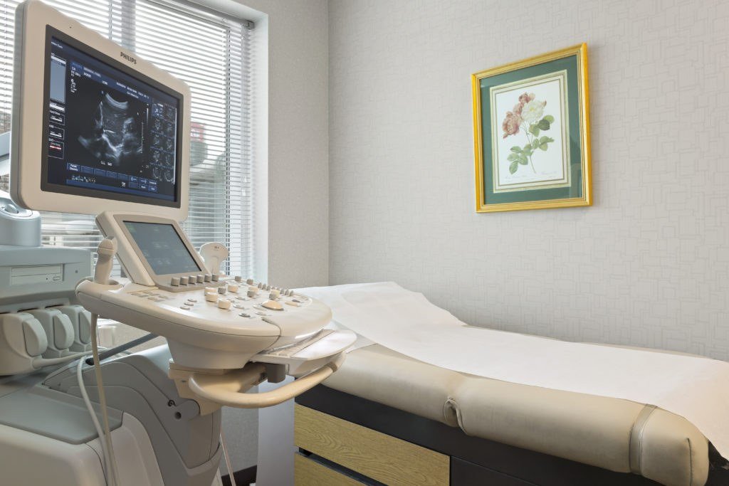 Ultrasound console with examination bed in the scan room