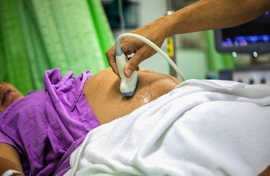 Sonographer scanning an expecting mother