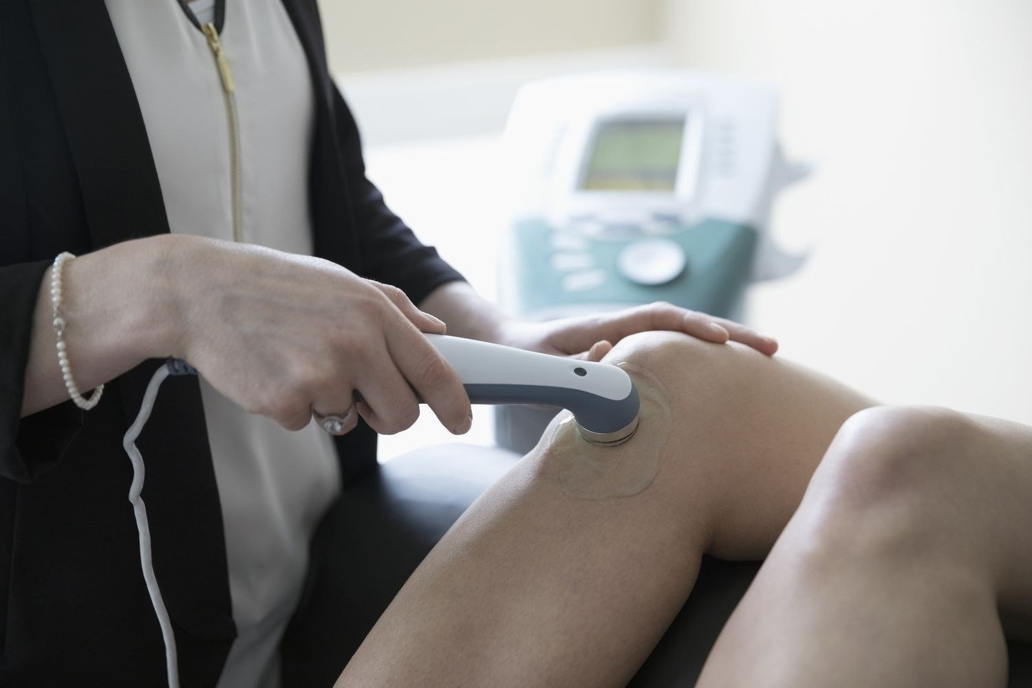 Therapeutic ultrasound treatment on a patient's knee joint