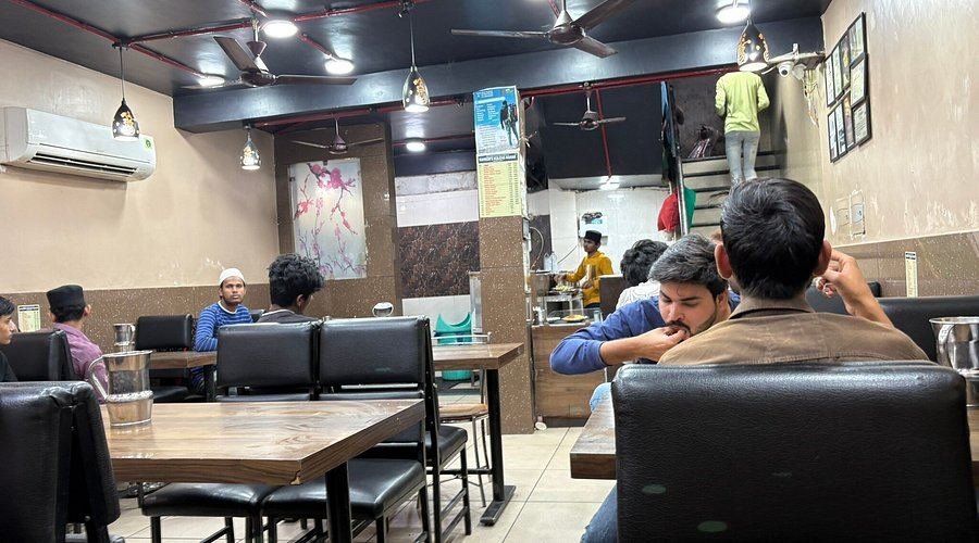 Dining interior with customers at Raheem's Kulcha Nahari, Chowk Lucknow