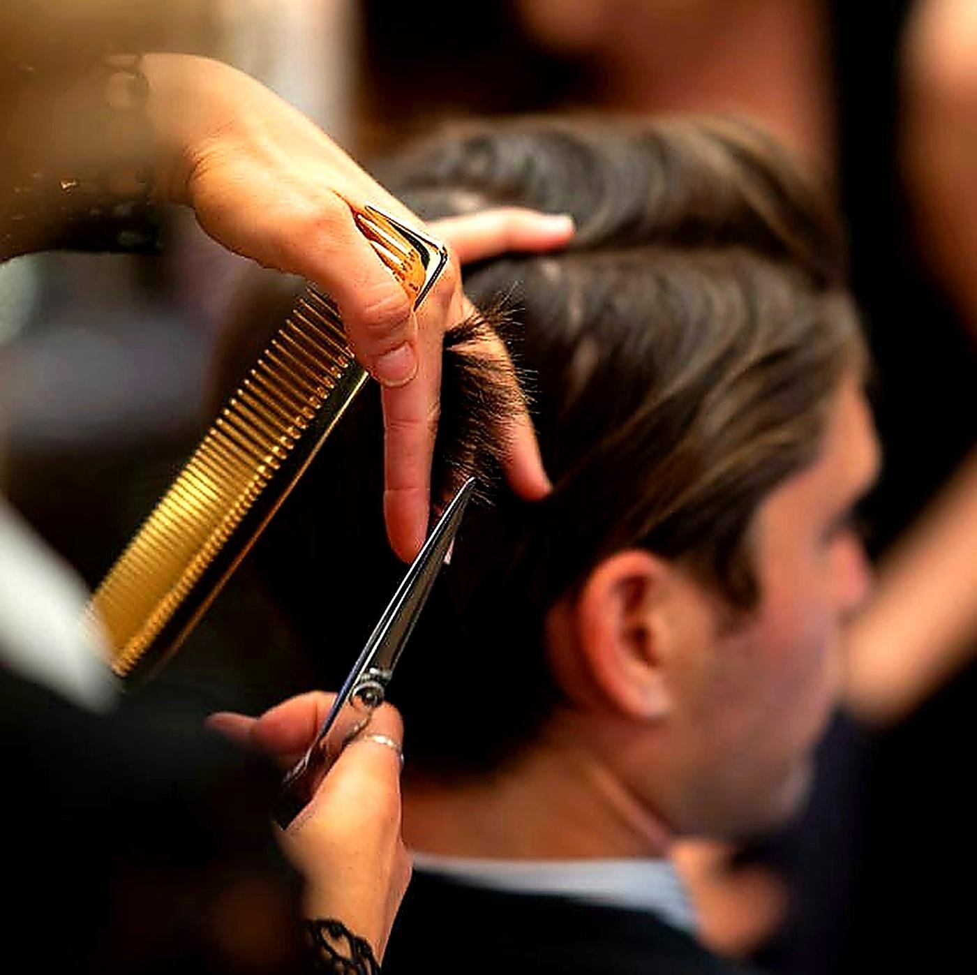 Barber scissor-over-comb haircut close-up