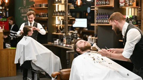 Busy modern barbershop with barbers at work