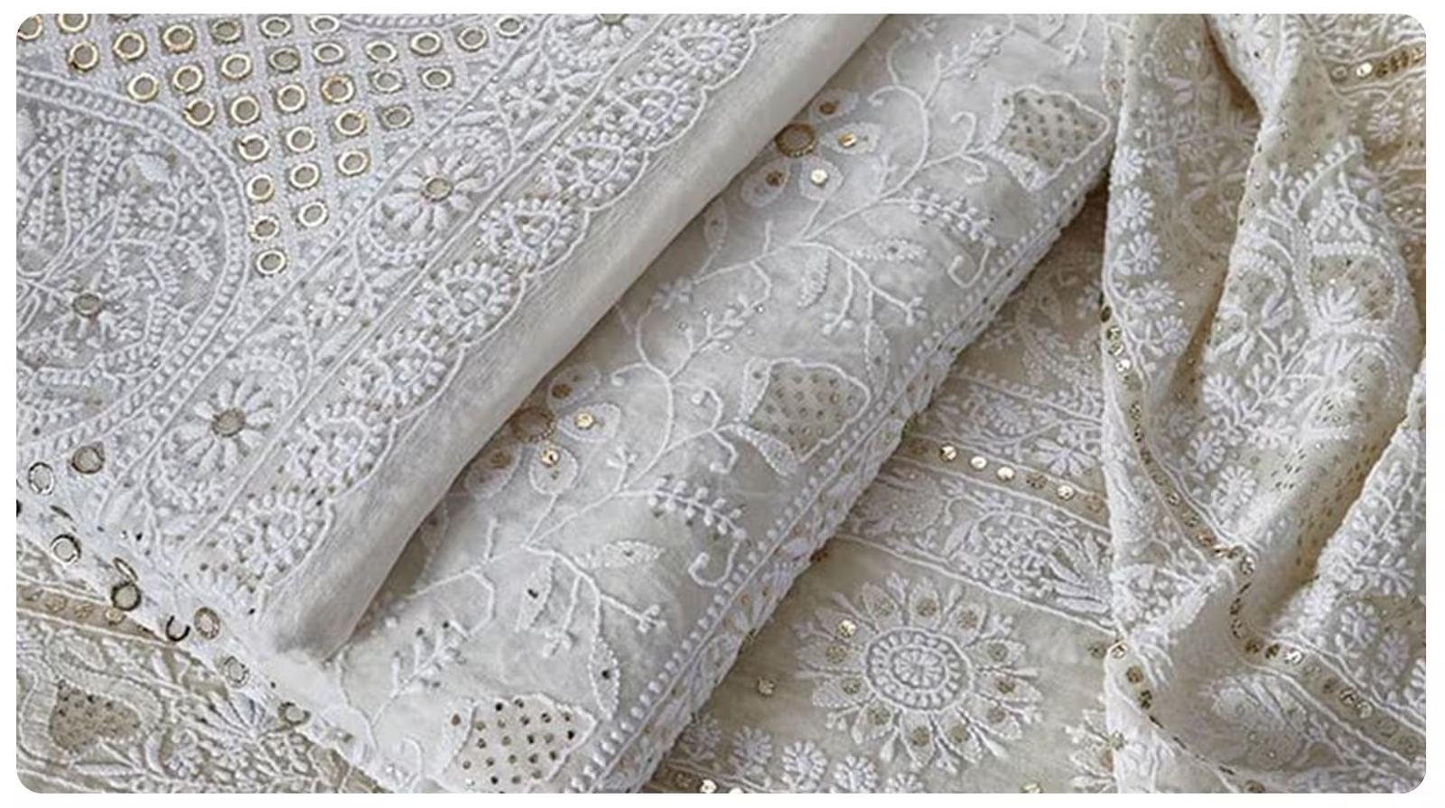White chikankari fabric with mukaish work close-up