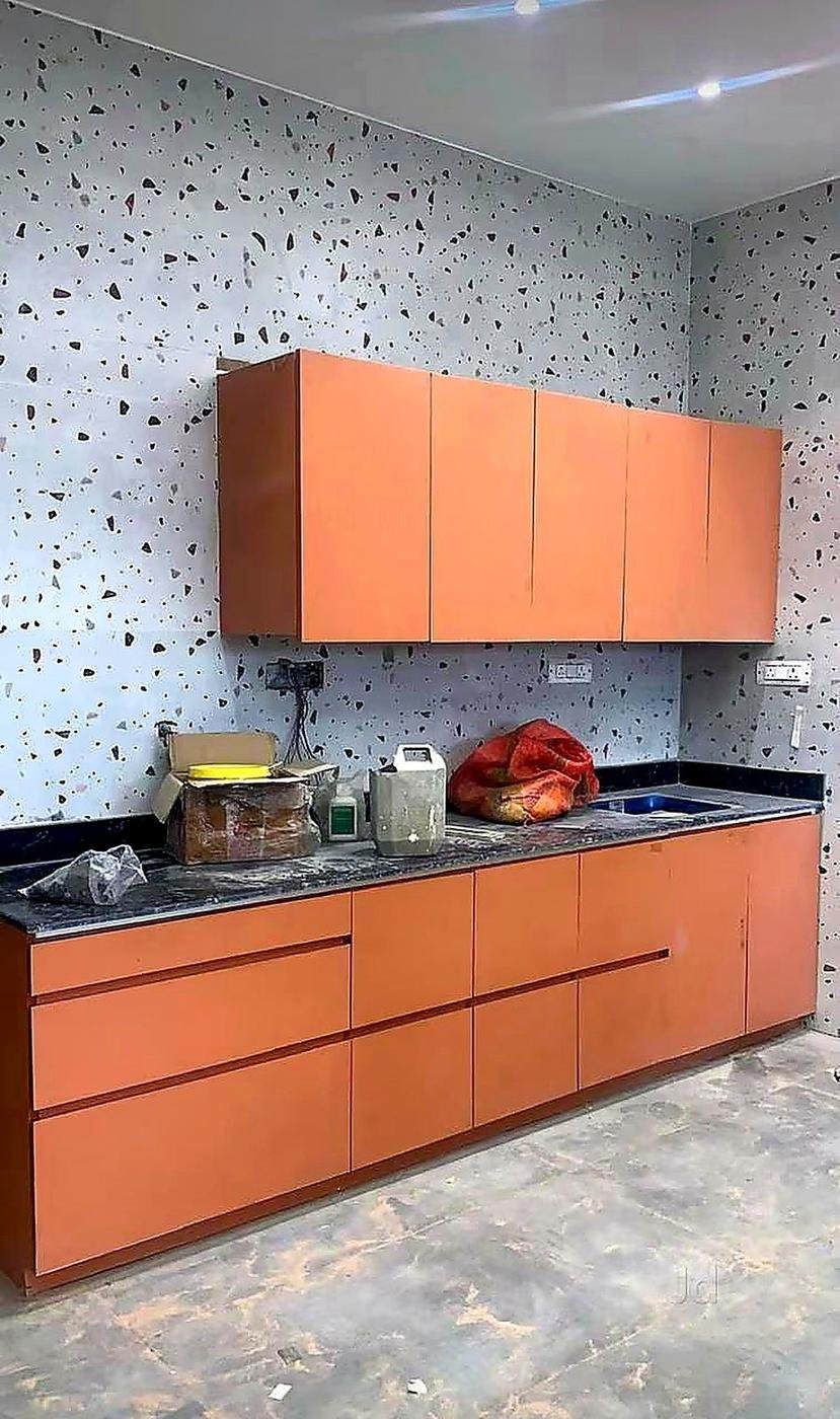 Orange modular kitchen cabinets built in our workshop — custom furniture in Kakori, Lucknow
