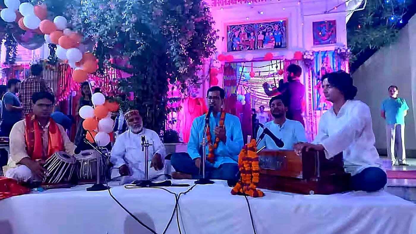 Live stage performance with vocals and harmonium by academy students