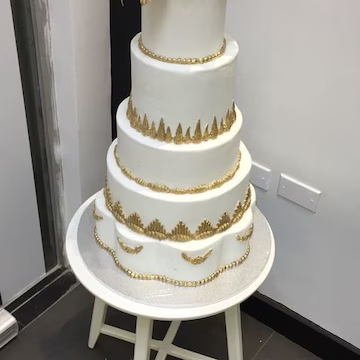 White tiered celebration cake by Shama Bakery Lucknow