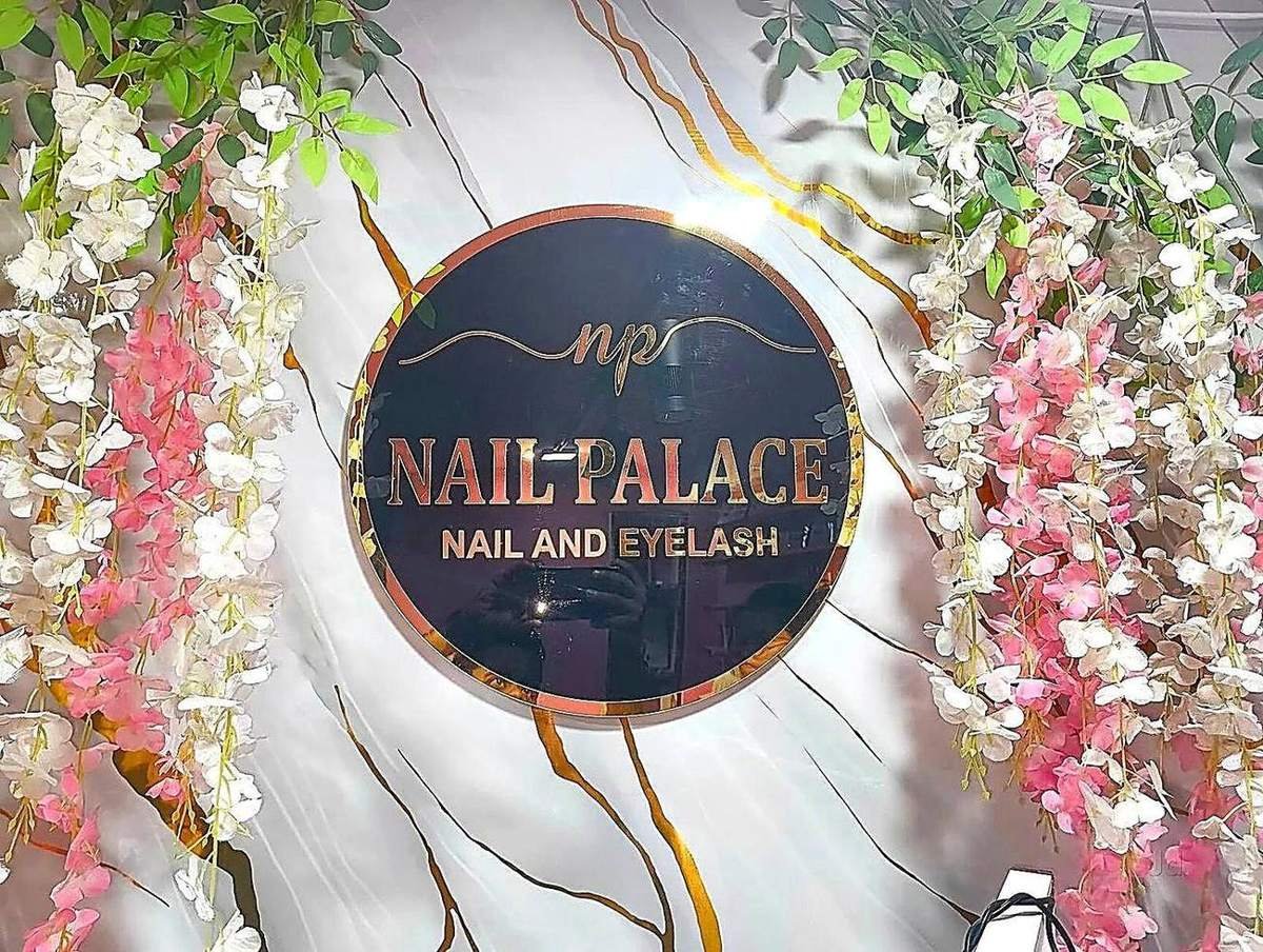The Nail Palace logo wall with floral decor at Charbagh studio Lucknow