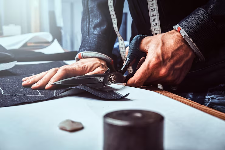 Tailor shears cutting suiting fabric close-up