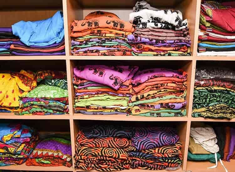 Shelves stacked with colourful sarees inside Vipin Sarees Aminabad